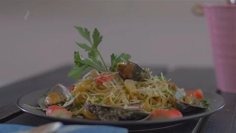 Sprinkling with Parmesan. Seafood paste and mussels Stock Footage 111670863