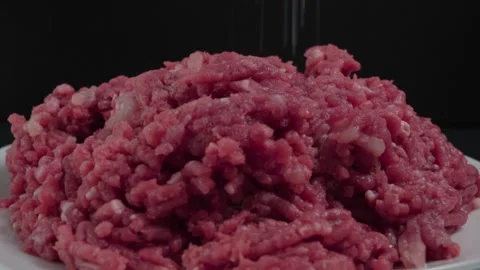 Sprinkling Salt onto Raw Ground Beef, Isolated Closeup Studio Shot 動画素材 134330480