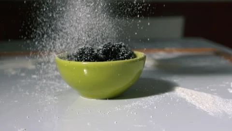Sprinkling sugar on blackberries Stock Footage 346772296
