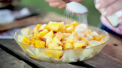 Sprinkling sugar onto fruit salad mixture Stock Footage 63292595