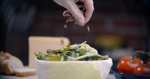 Sprinkling toppings on top of a salad Stock Footage 101598626