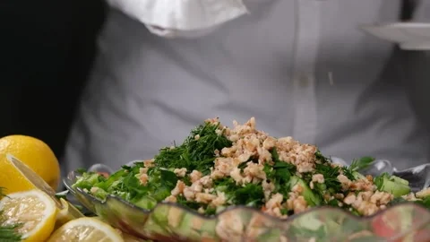 Sprinkling walnuts on salad Stock Footage 228995265