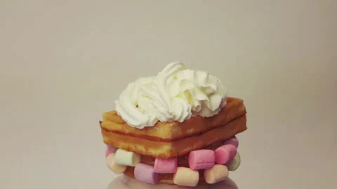Sprinkling whipped cream on the waffle Stock Footage 100678063