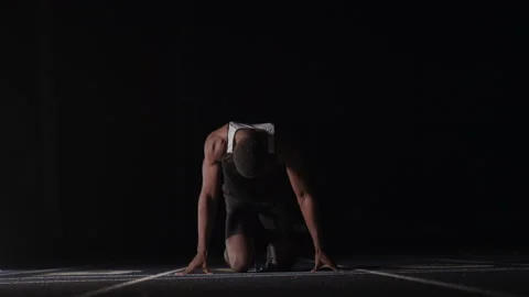 Sprinter Easing Into His Blocks Stock Footage 208743276