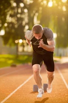 Sprinter leaving starting blocks on the running track. Explosive start 写真素材