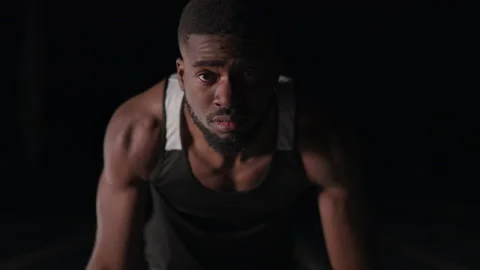 Sprinter Looking up From His Starting Blocks Stock Footage 208743044