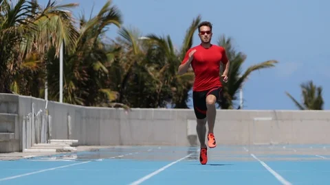 Sprinter man running sprint training on athletics track and field stadium Stock Footage 117956527