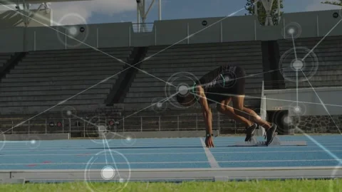 Sprinter reacting to start cue, pushing off blocks to sprint while motion Stock Footage 330236844
