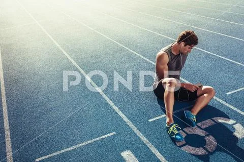 Sprinter Relaxing On Running Track