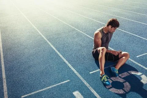 Sprinter relaxing on running track Stock Photos