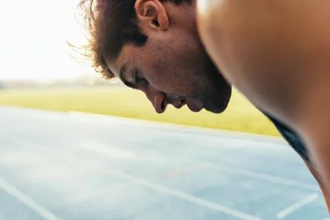 Sprinter standing on running track Stock Photos