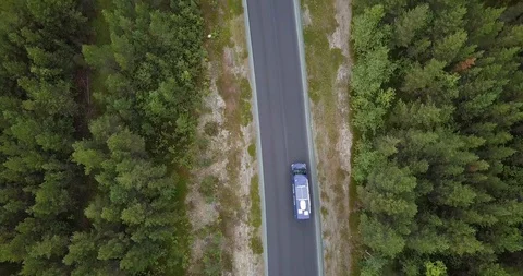 Sprinter Van driving through norwegian forest from above Stock Footage