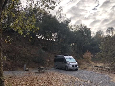 Sprinter Van RV Parked at Forested Campground Stock Photos