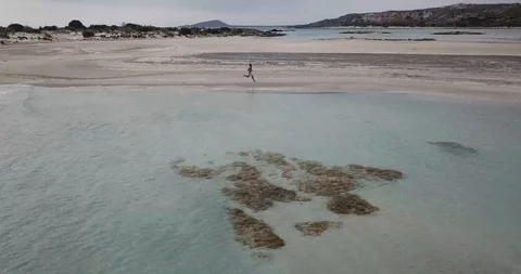 Sprinting on Beach in Greece Drone Shot Stock Footage 106340618