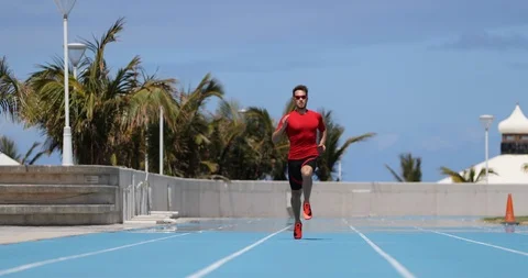 Sprinting man sprinter running sprint training on track and field stadium Stock Footage 117941472