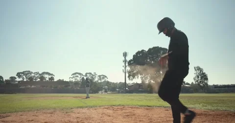 Sprinting toward base bag, runner sliding headfirst under glove to avoid tag at Stock Footage 335985865