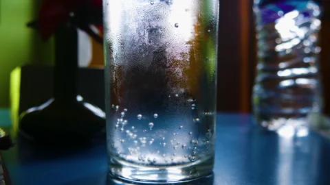 Sprite cold drink in a glass with bubbles going up along background Stock Footage 247813442