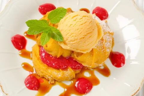 Spritz cookies with raspberry sauce and ice cream Stock Photos