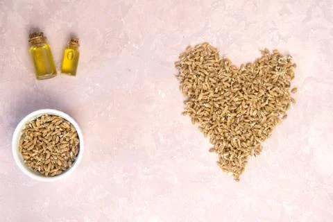 Sprouted wheat in shape of heart on a light background. toned Stock Photos