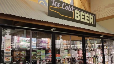 Sprouts retail upscale grocery store interior tilt of beer section and decor Stock Footage 161438881