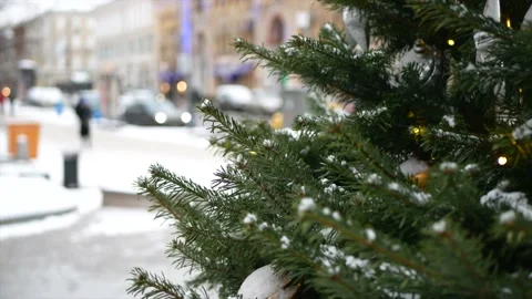 Spruce branches with snow on it and Christmas toys in the foreground and wint Stock Footage 139850034