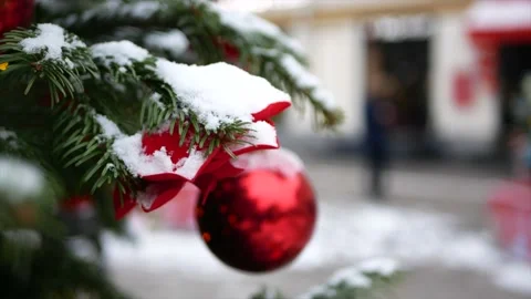Spruce branches with snow on it and Christmas toys - red balls in the foregro Stock Footage 139850037