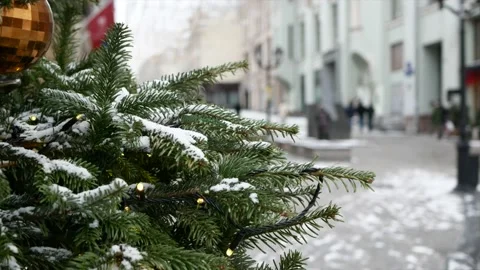 Spruce branches with snow on it and Christmas toys in the foreground and wint Stock Footage 139850044