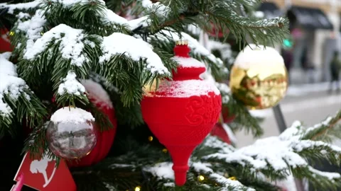 Spruce branches with snow on it and Christmas toys in the foreground and wint Stock Footage 139850059