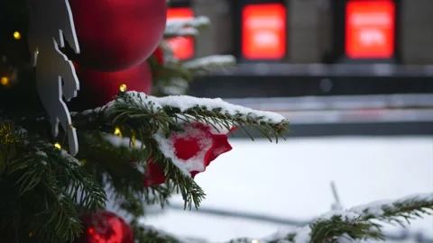 Spruce branches with snow on it and Christmas toys in the foreground and wint Stock Footage 139850065