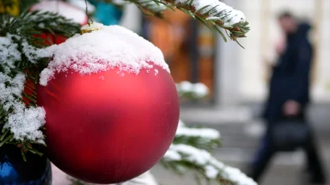 Spruce branches with snow on it and Christmas toys - red balls in the foregro Stock Footage 139850079