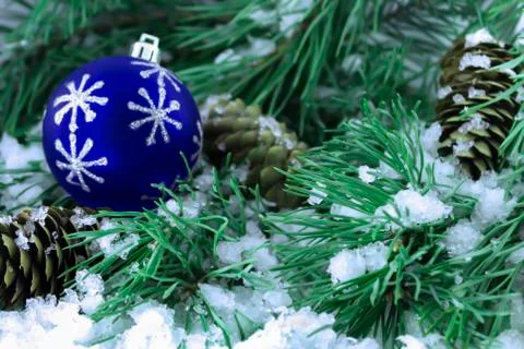 Spruce branches in the snow with pine cones and a toy Stock Photos