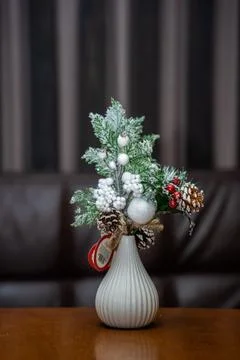Spruce branches standing in a vase on the table. Minimalist Christmas decor Stock Photos
