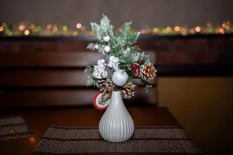 Spruce branches standing in a vase on the table. Minimalist Christmas decor Stock Photos