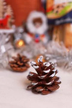 Spruce coniferous cone on the table festive atmosphere blurred background Stock Photos