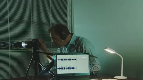 Spy in action - covert surveillance using a gun microphone, laptop and camera. Stock Footage 310174955