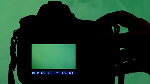 Spy soot on dslr camera watch on green screen Stock Footage 87626927