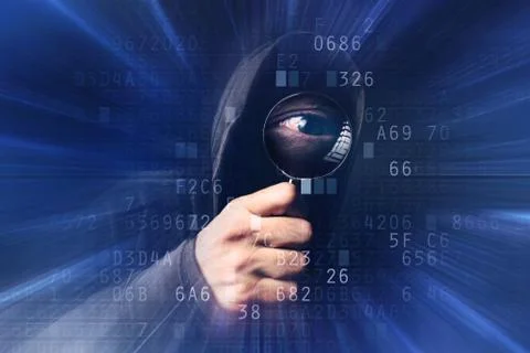 Spyware software, hooded hacker with magnifying glass analyzing computer code Stockfoto's