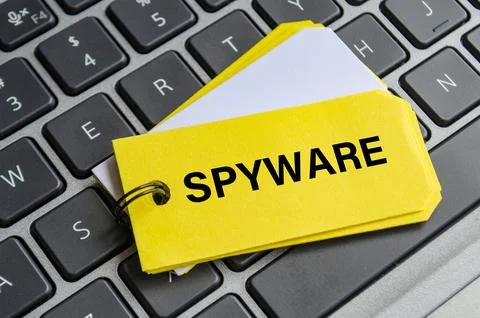Spyware text on white notepad with laptop keyboard background. Hacker and s.. Stock Photos