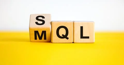 SQL or MQL symbol. Turned wooden cubes and changed words 'MQL marketing quali Stock Photos