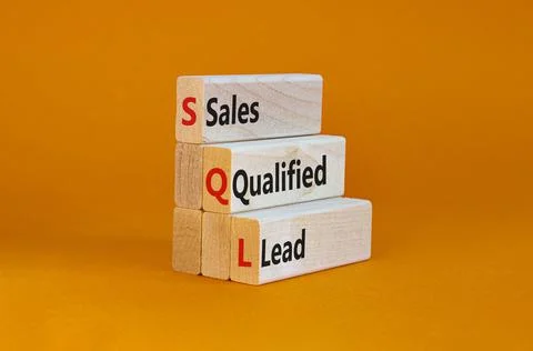 SQL sales qualified lead symbol. Wooden blocks with words 'SQL sales qualifie Foto stock