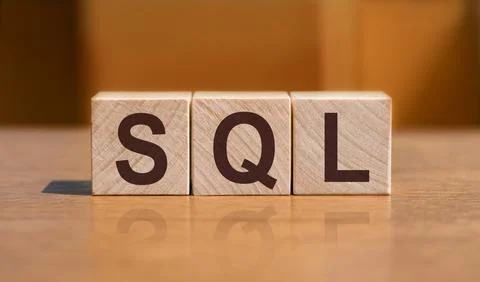 SQL text Structured Query Language on wooden cubes on orange background. Stock Photos