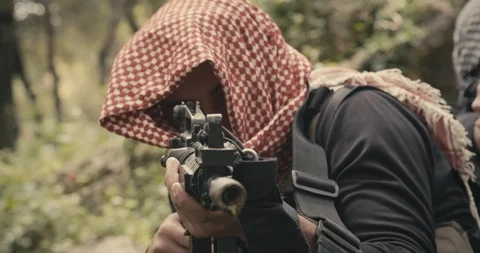 Squad of armed islamic isis terrorists patrolling a forest area during combat Vidéo 106684045