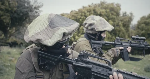 Squad of fully armed commando soldiers during combat in a forest scenery Stock Footage 106683474
