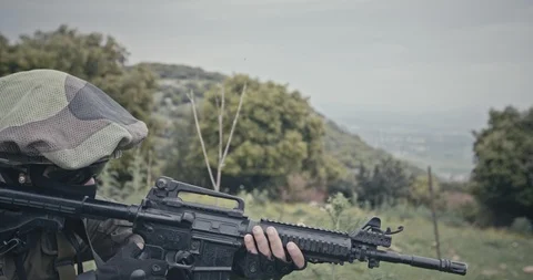 Squad of fully armed commando soldiers during combat in a forest scenery Stock Footage 106683495