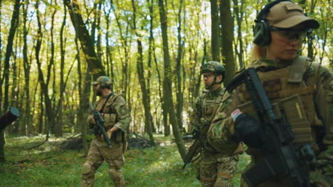 Squad of fully equiped soldiers in uniform holding weapons in hands and walking Stock Footage 241004215