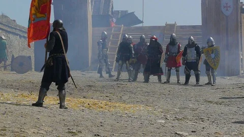 A squad of medieval knights stands in a line in front of the standard bearer Video stock 122079005