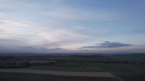 Squall-type cloud with fields and mountains in the background Stock Footage 259407187