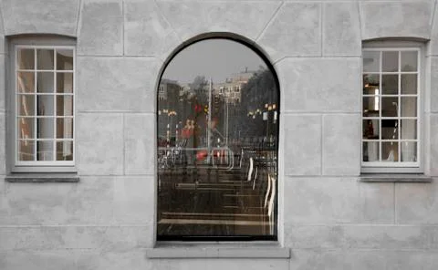 Square and semicircular window on a gray wall. Reflection in the windows. Stock Photos