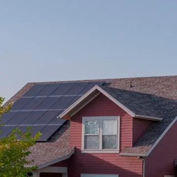 Square Array of photovoltaic solar panels on a roof Stock Photos