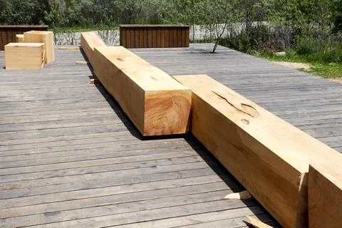 Square bars of the bench made of a single trunk of the Tien Shan spruce Stock Photos